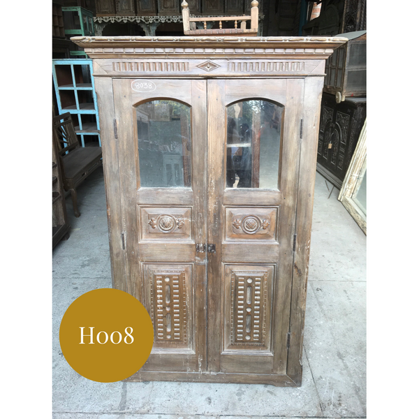 Vintage carved cupboard door in frame with glass windows